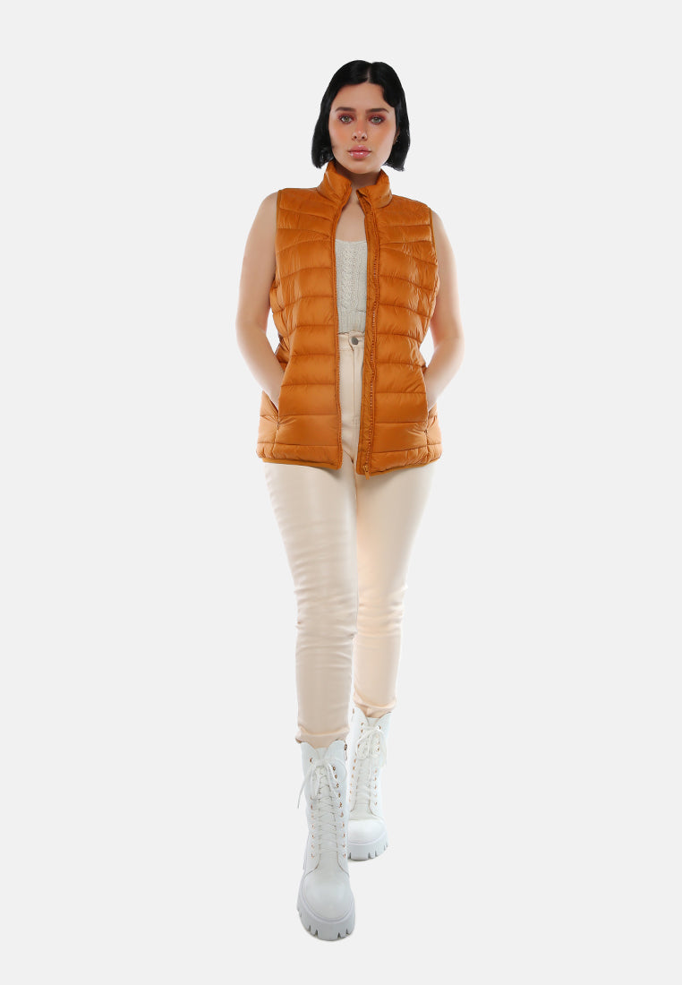 sleeveless puffer jacket in tangerine#color_mustard