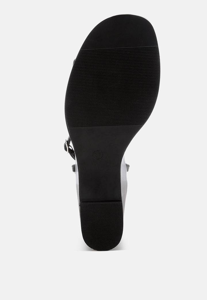 sangria solid platform faux leather wedges by motes#color_black