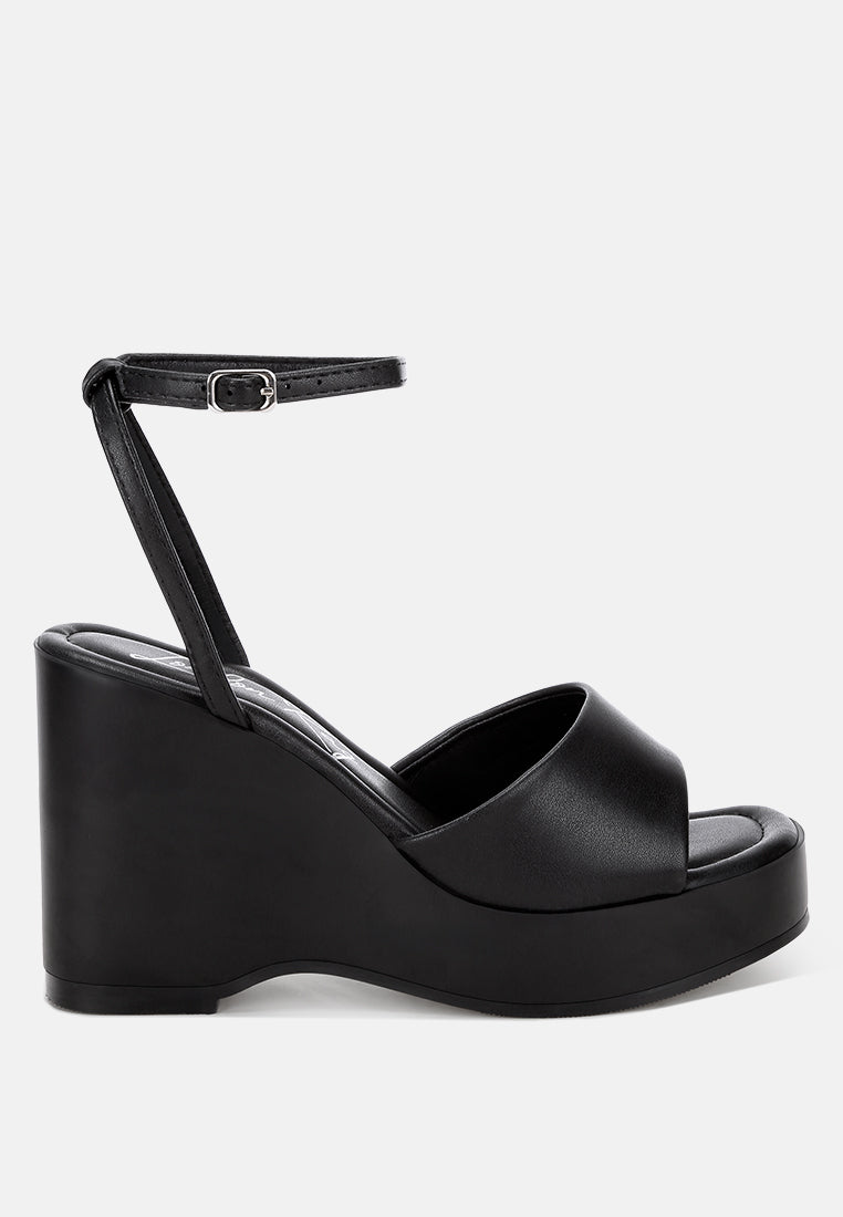 sangria solid platform faux leather wedges by motes#color_black