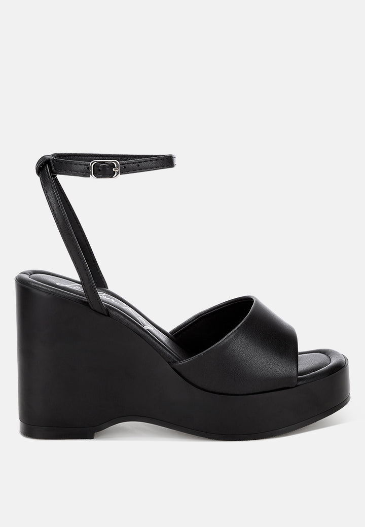 sangria solid platform faux leather wedges by motes#color_black