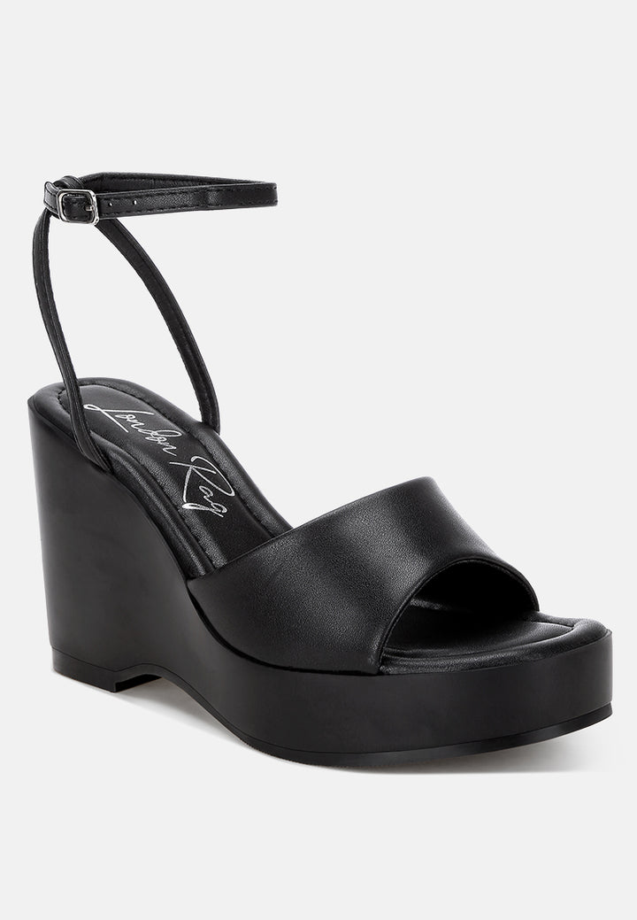 sangria solid platform faux leather wedges by motes#color_black
