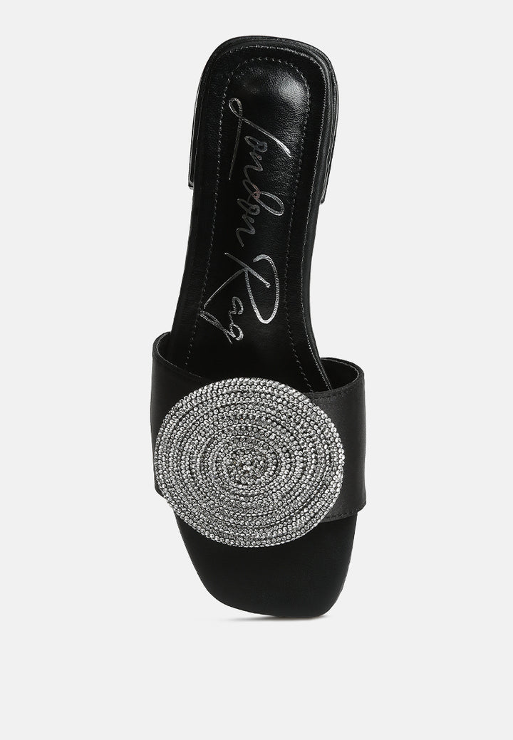 ollilie rhinestones embellished brooch slip on sandals in black#color_black